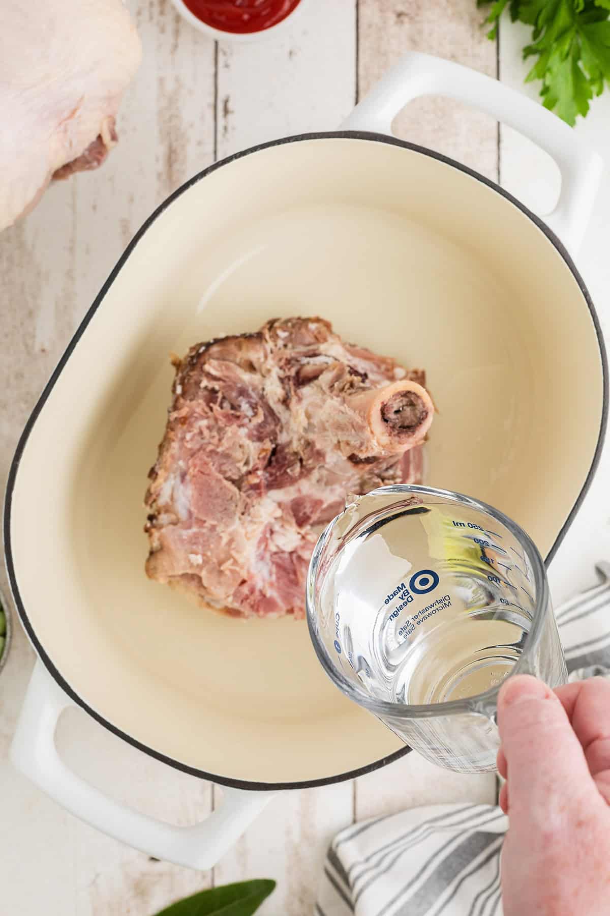 A leftover smoked ham bone in a large pot with water.