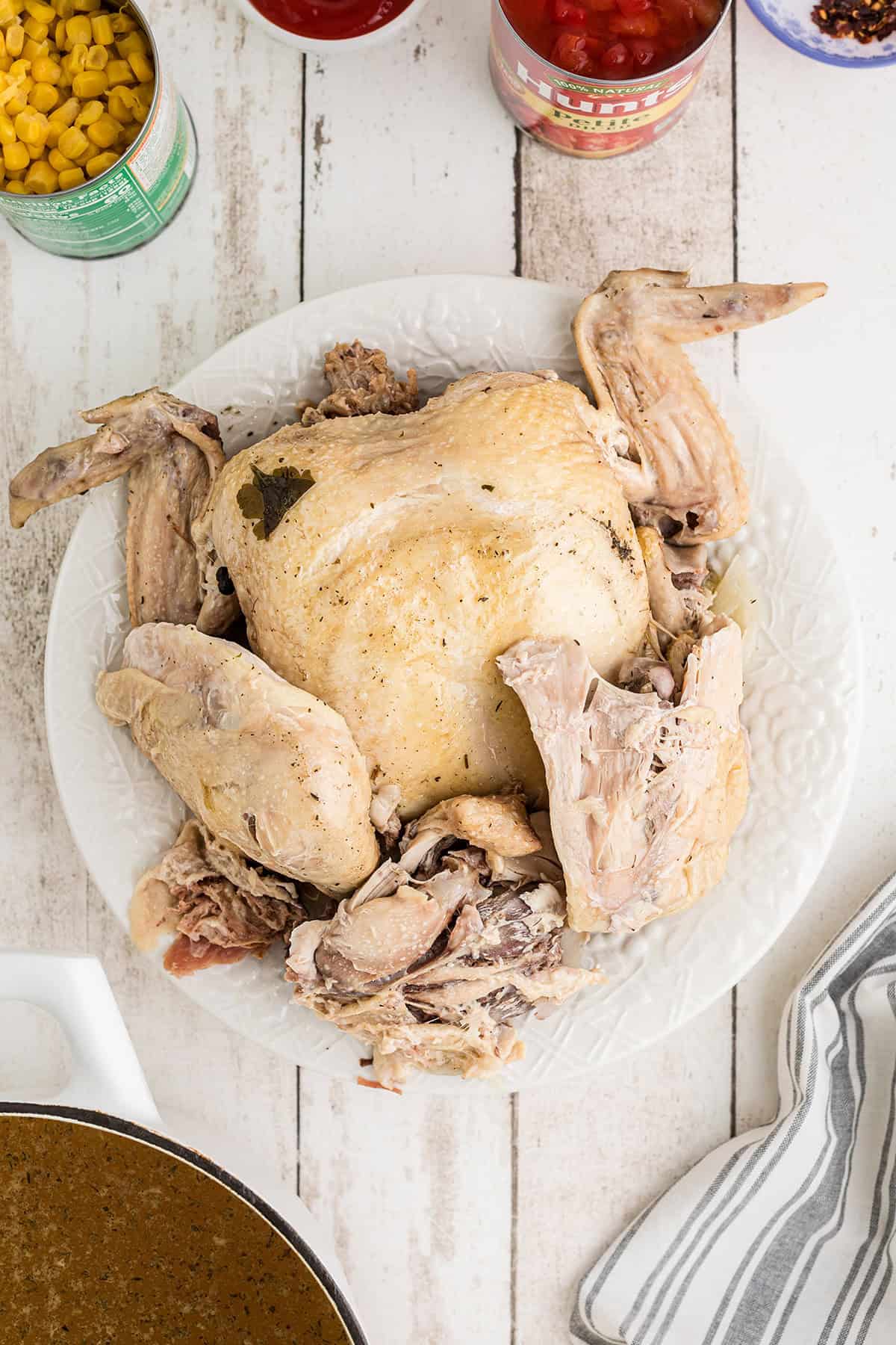Removing chicken from skin and bones.
