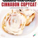 Two frosted cinnamon rolls on a white plate with text overlay: “Cinnamon Rolls Cinnabon Copycat.”.