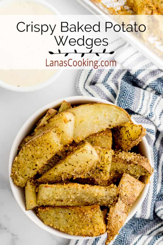A white bowl containing a serving of crispy baked potato wedges.