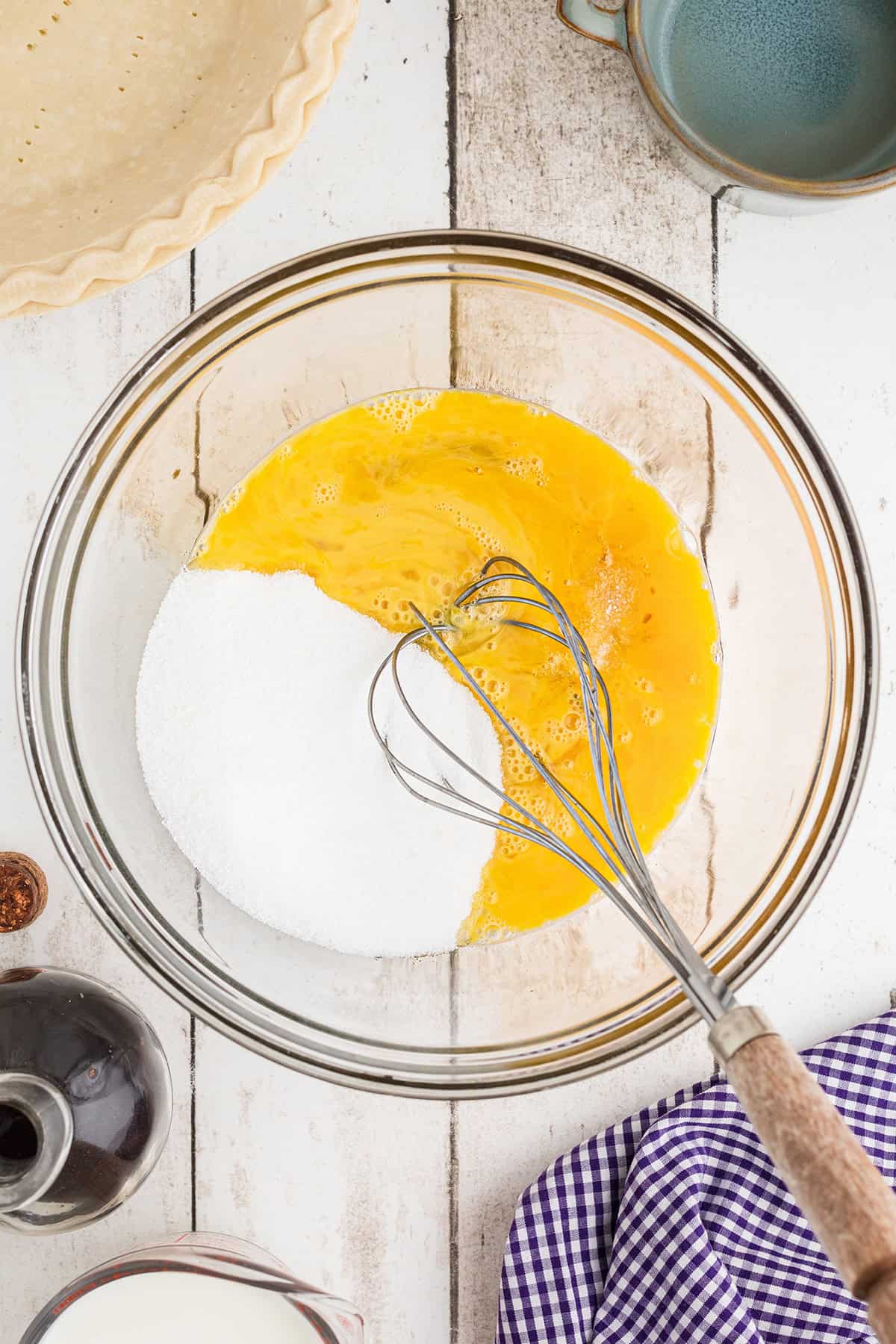Eggs, sugar, salt, and vanilla in a bowl.