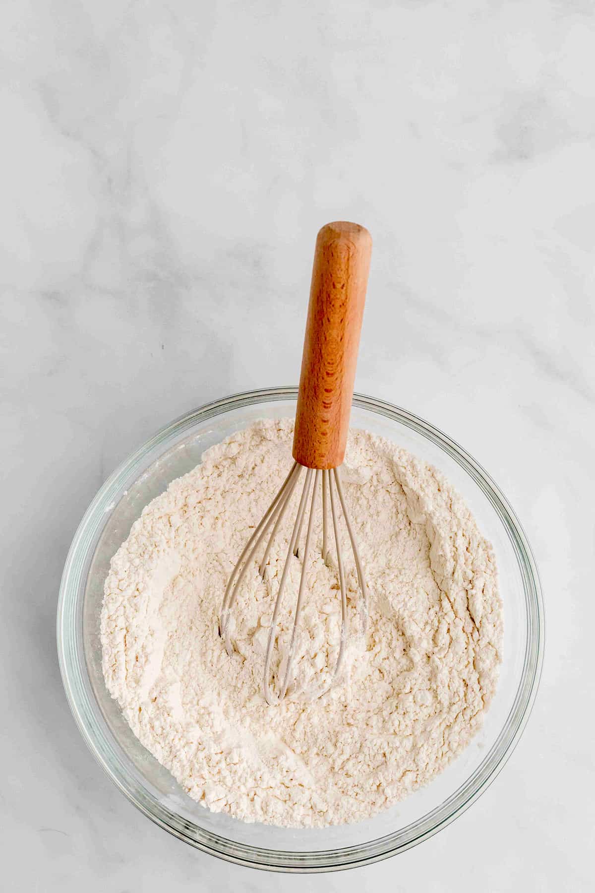 Mixing dry ingredients together with a whisk.