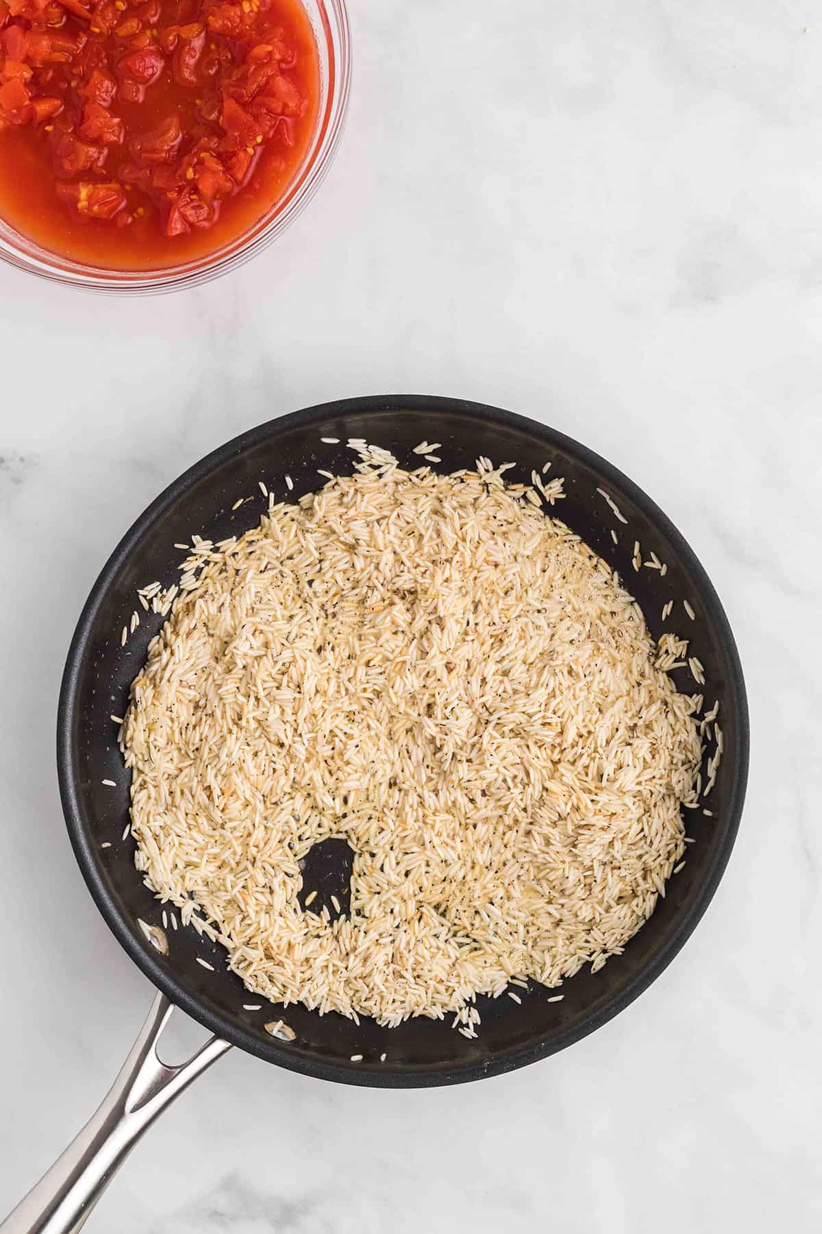 Browned rice in a skillet.