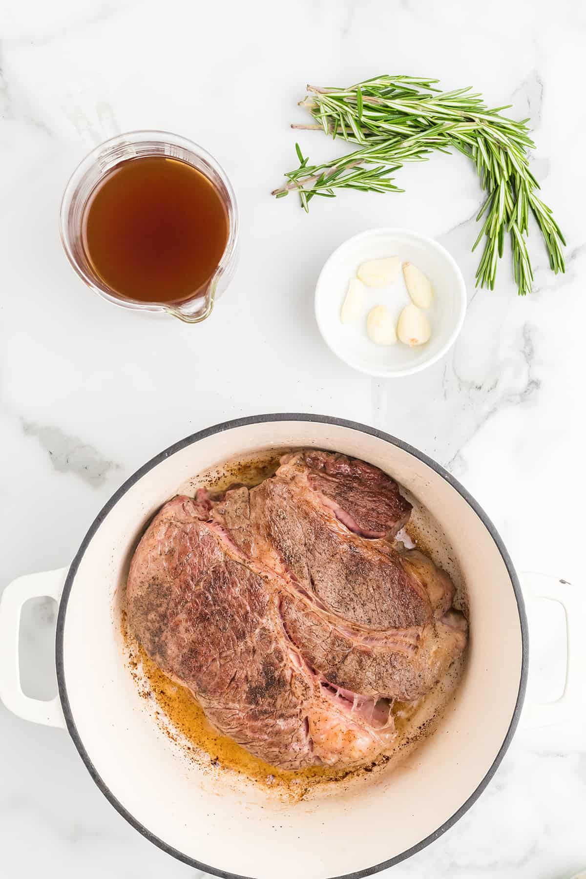 Browning the roast in a  Dutch oven.