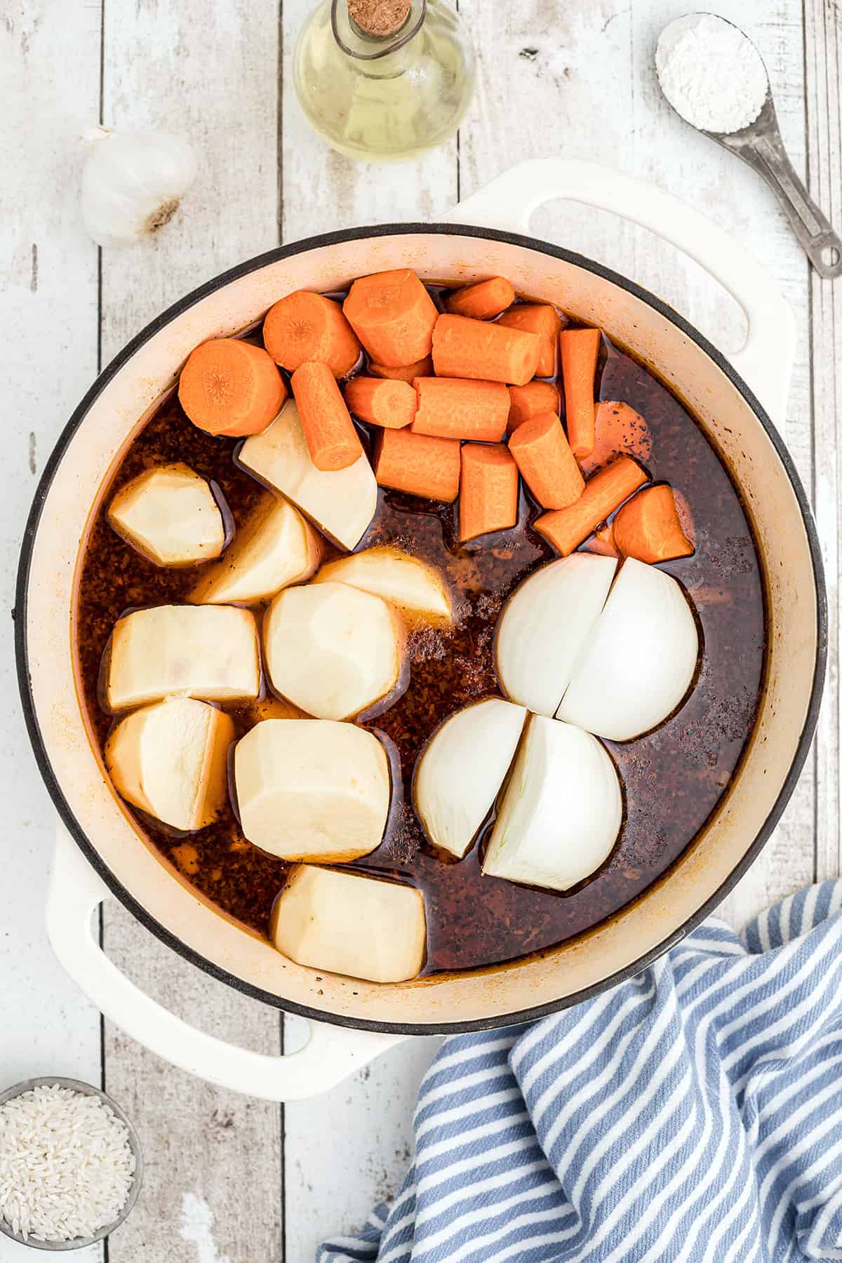 Carrots, potatoes, and onions added to the pot.