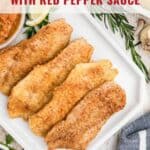 Four pieces of pan-fried fish on a white plate, served with red pepper sauce and fresh herbs.