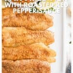 Four pieces of pan-fried fish fillets on a white tray, topped with roasted red pepper sauce.