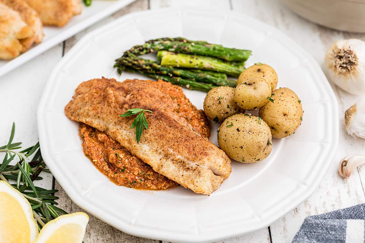 Pan Fried Fish with Roasted Red Pepper Sauce is comfort food at its finest. You'll be amazed that a dish this fantastic takes only 30 minutes! https://www.lanascooking.com/pan-fried-fish-with-red-pepper-sauce/