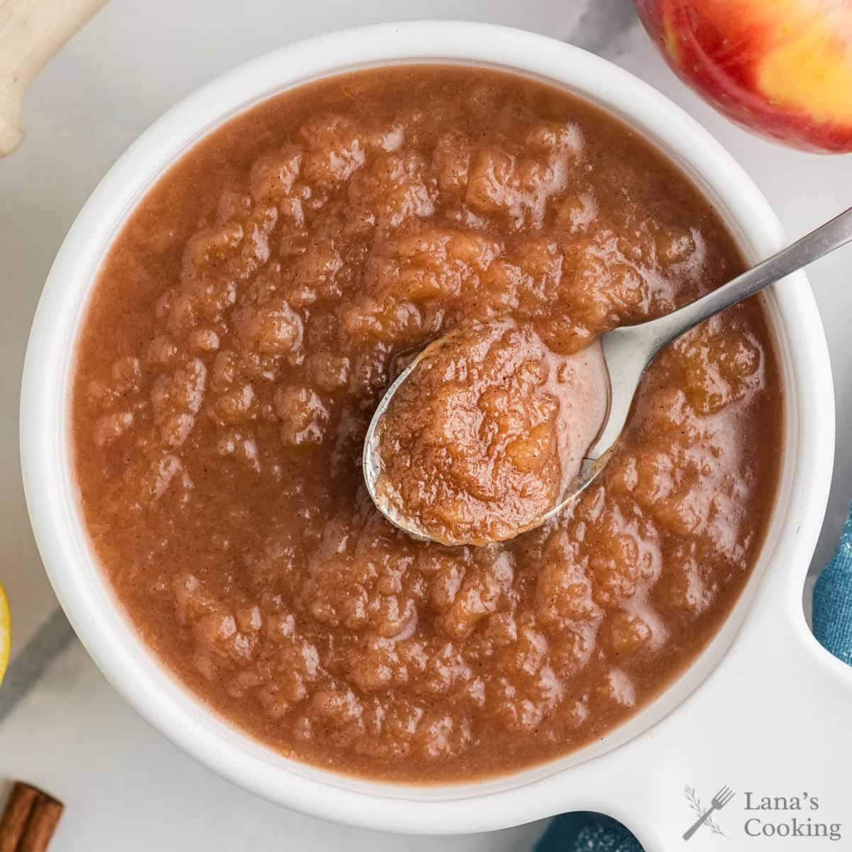 A serving of applesauce in a white bowl.