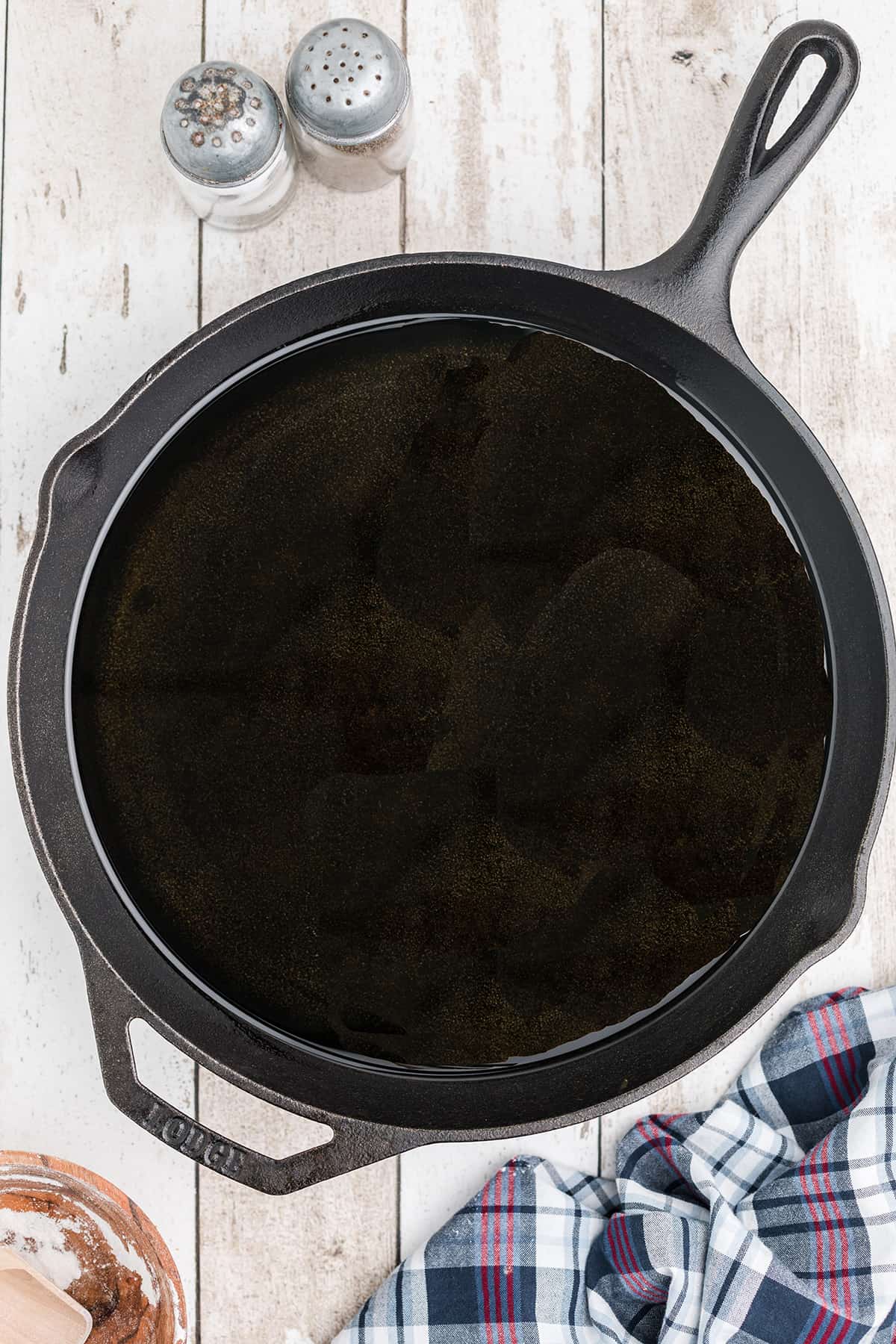 Oil heating in a cast iron skillet .