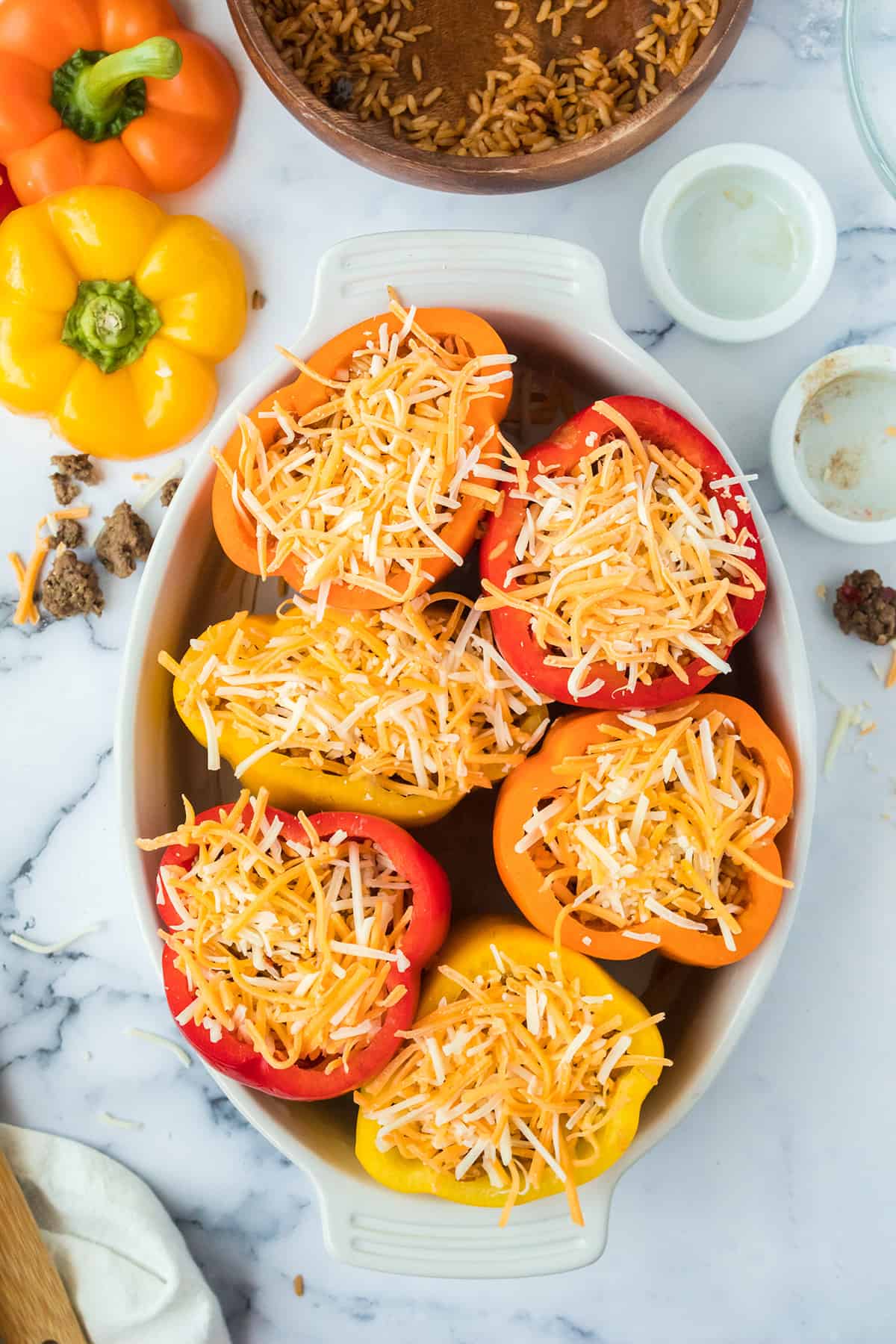 Cheese added to tops of peppers.