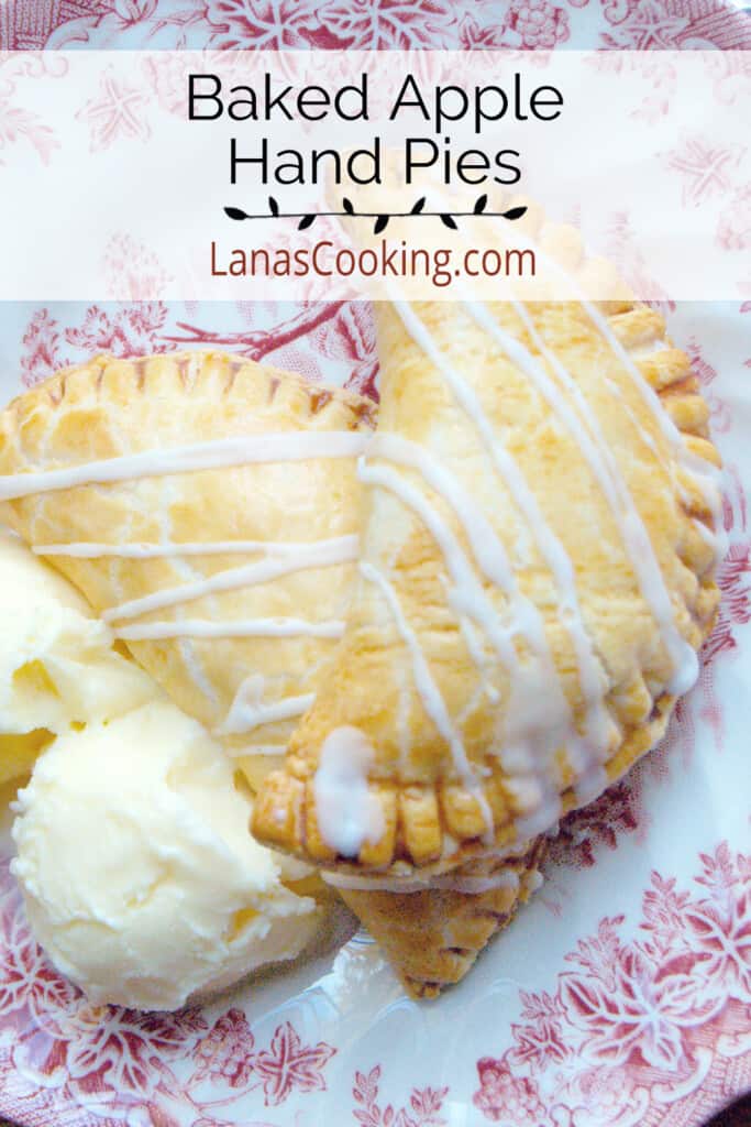 Two hand pies with vanilla ice cream on a serving plate.