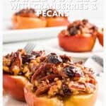 Baked apples filled with cranberries and pecans on a white plate, labeled as a perfect fall dessert.