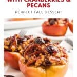 Baked apples stuffed with cranberries and pecans on a white plate, labeled as a perfect fall dessert.