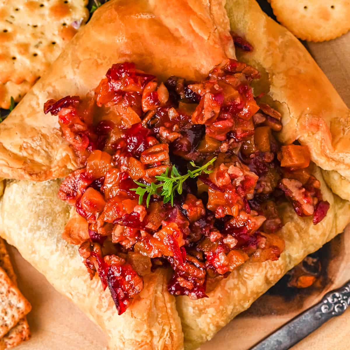 Finished baked brie on a serving board.