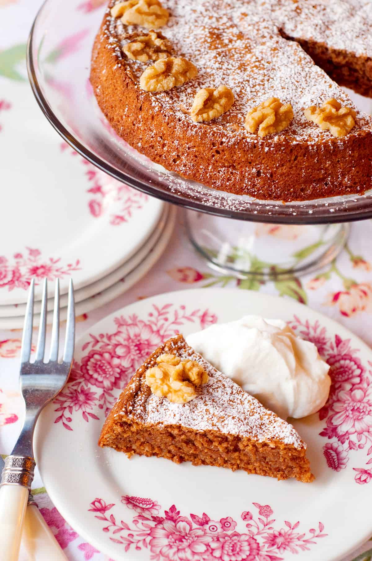 A slice of flourless walnut cake on a serving plate.