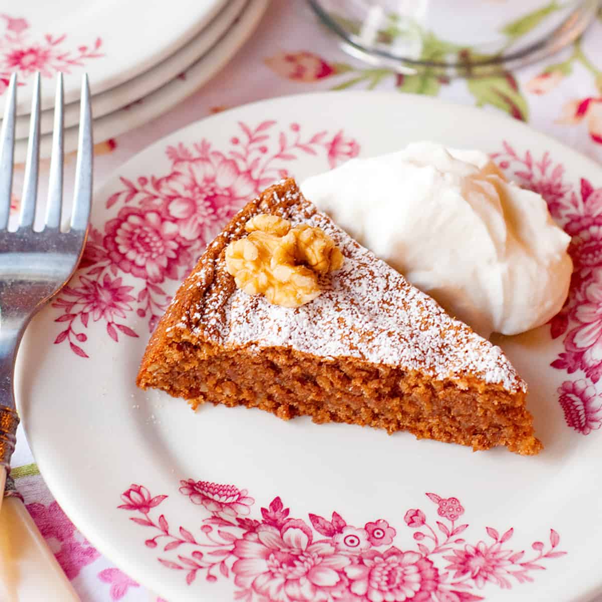 A slice of flourless walnut cake on a serving plate.