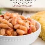 A serving of great northern beans in a white bowl.