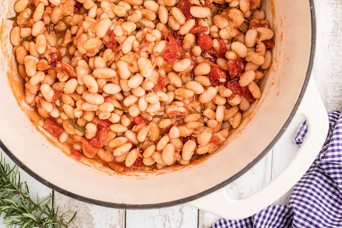 Finished great northern beans in a white pot.