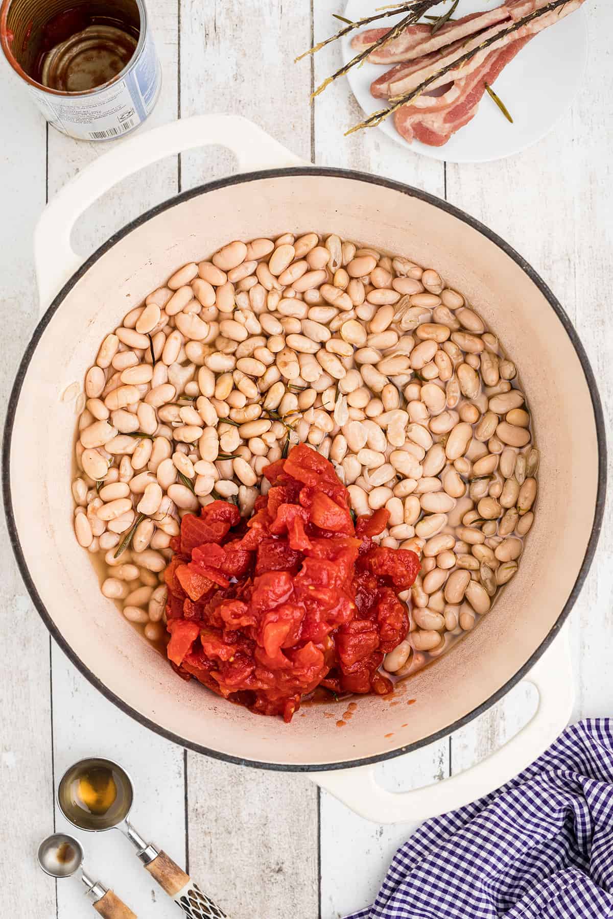 Tomatoes and remaining ingredients added to partially cooked beans.