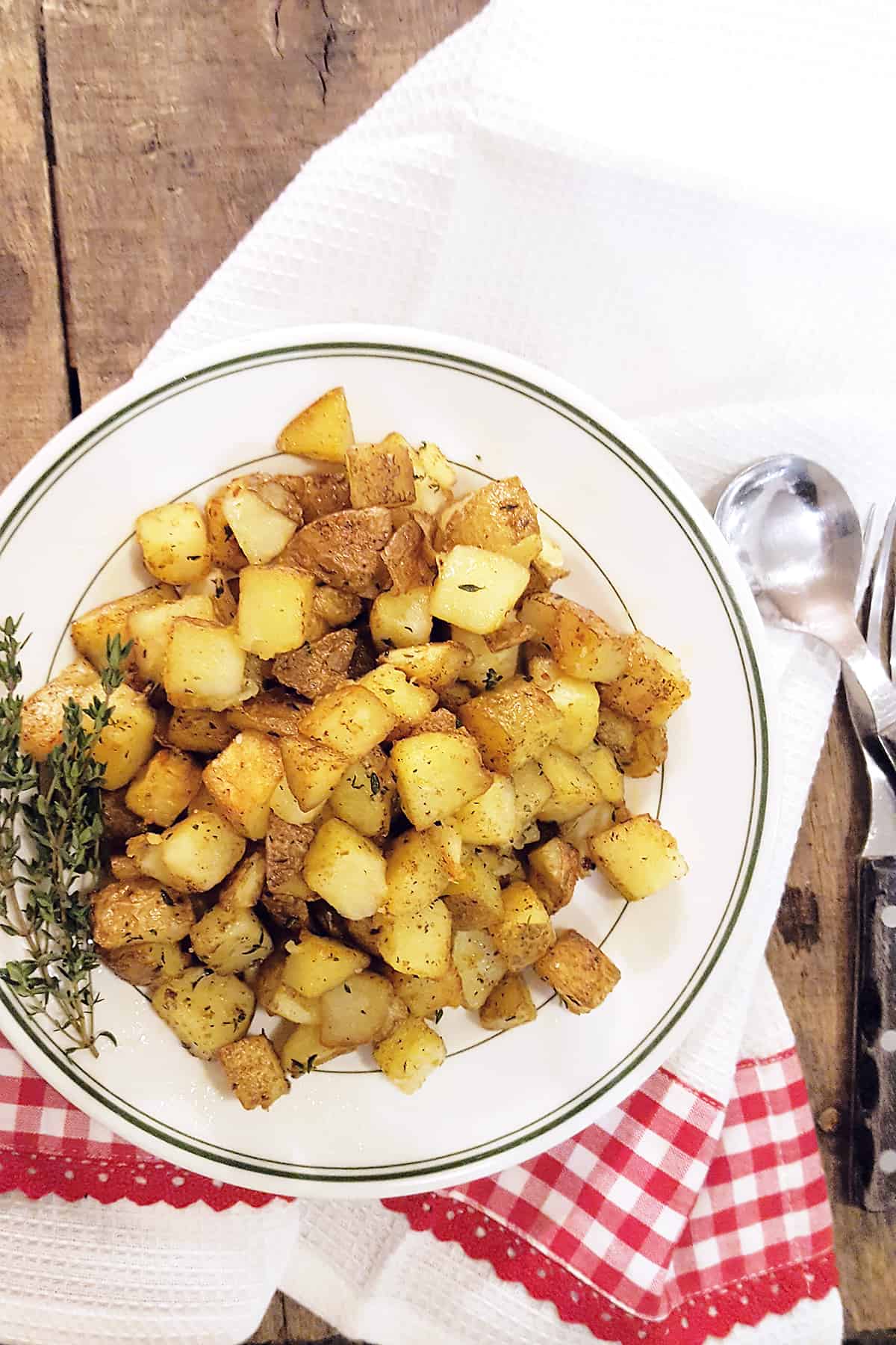 Home fries on a white serving plate.