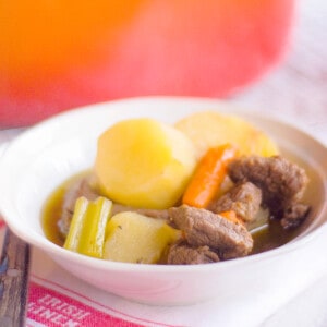 A serving of Irish stew in a white bowl.