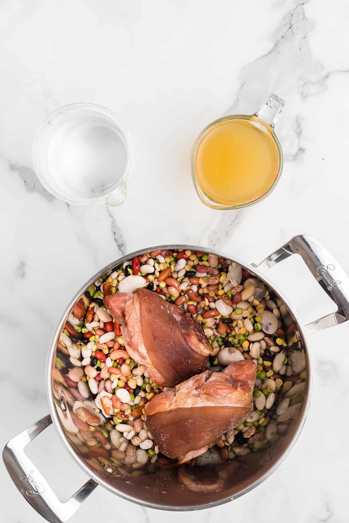 Prepared beans and ham hocks in a Dutch oven.