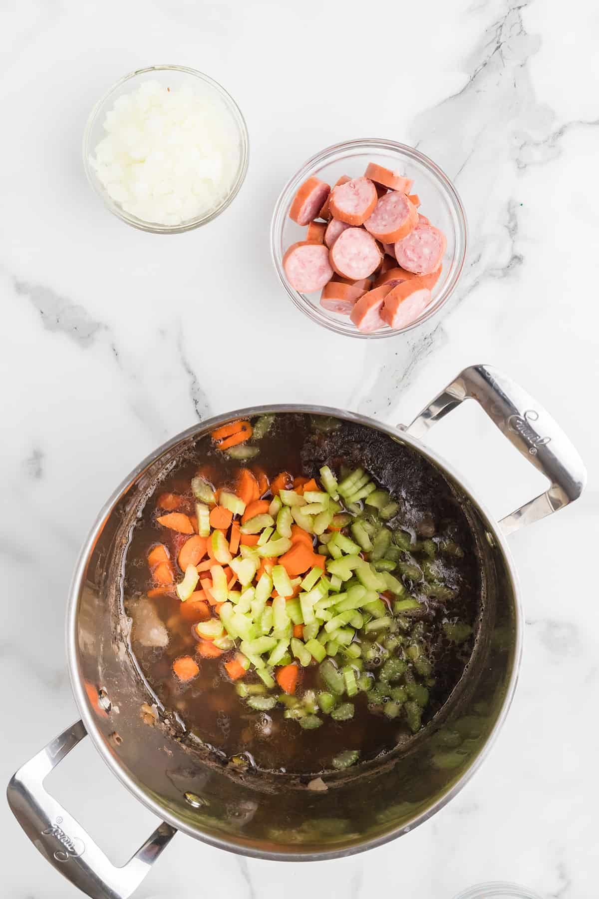 Remaining ingredients being added to the soup pot.