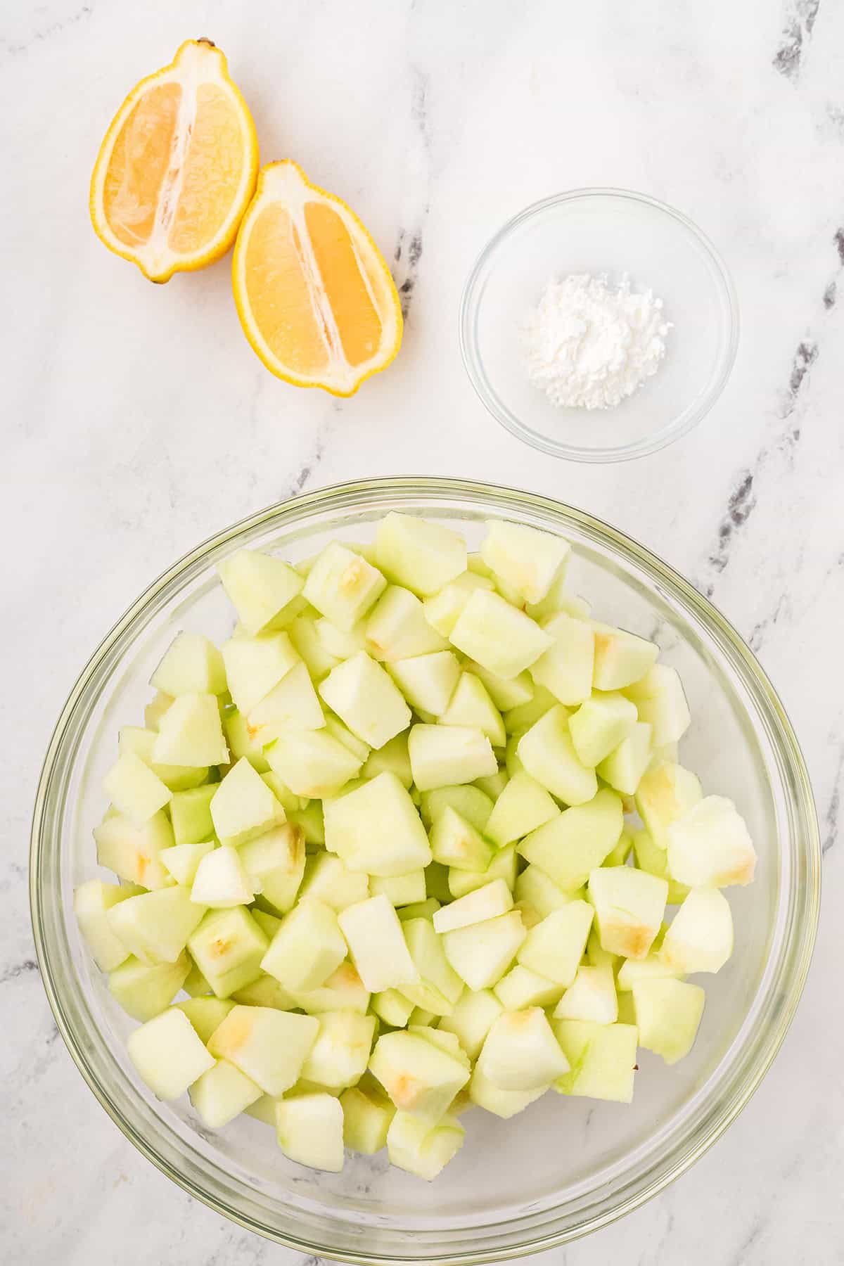 Cored, peeled, and cubed apples in a bowl.