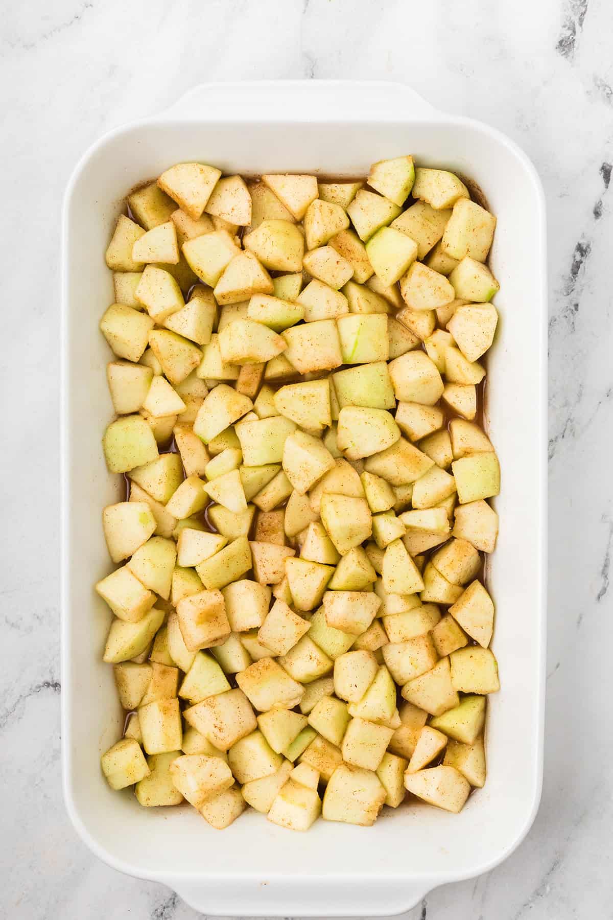 Apples spread into the baking dish.