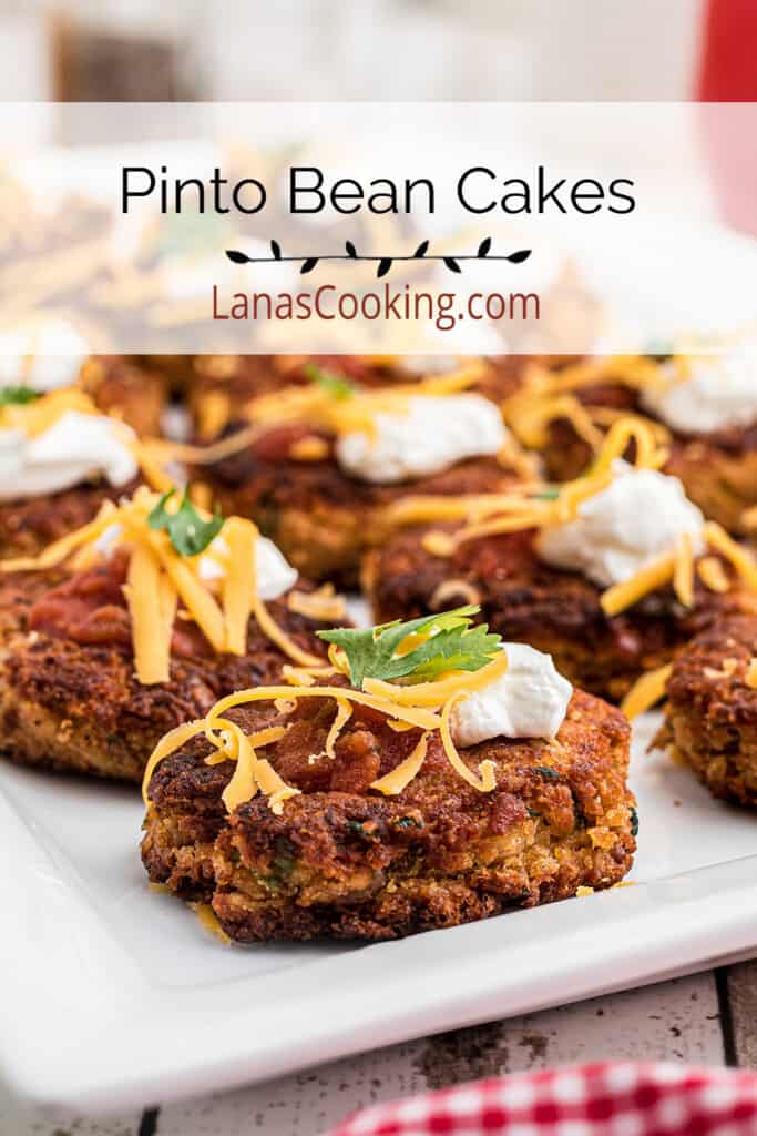 Finished pinto bean cakes on a white serving plate.