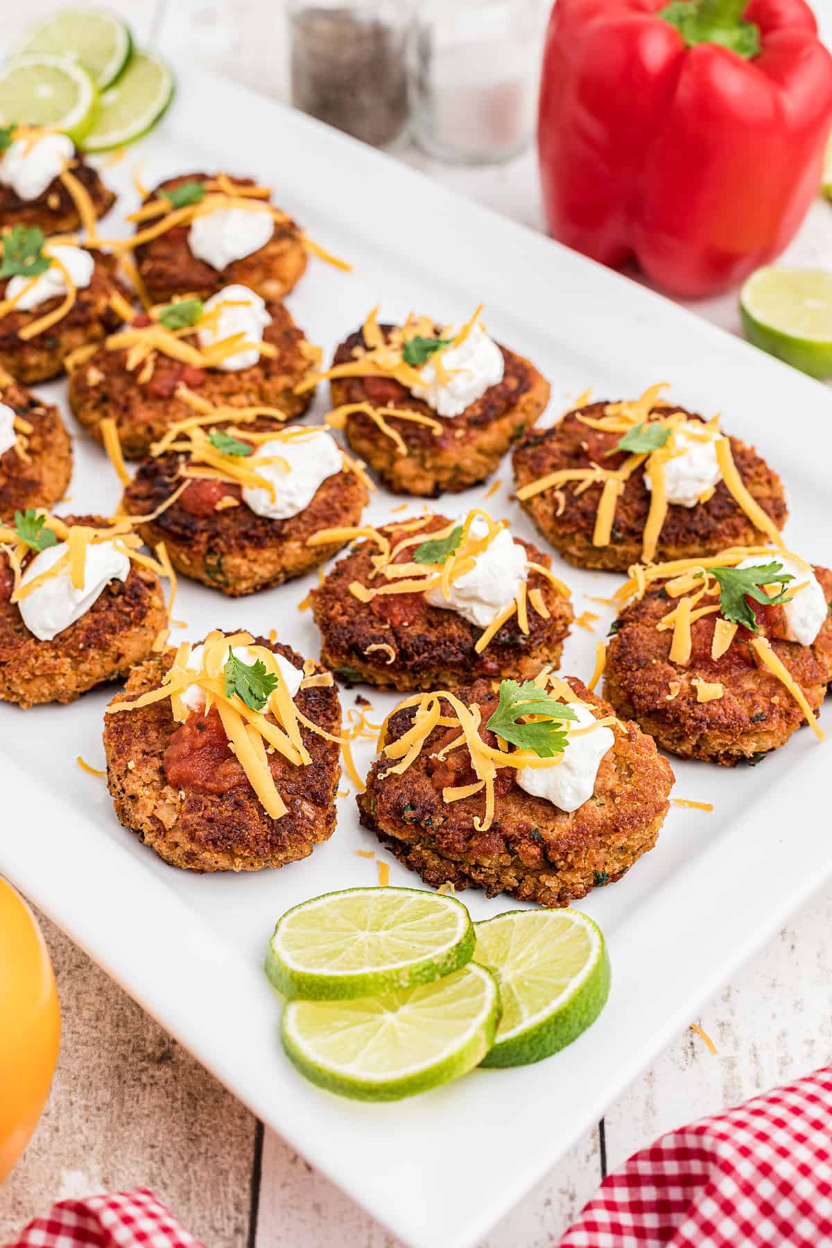 Finished pinto bean cakes on a white serving plate.