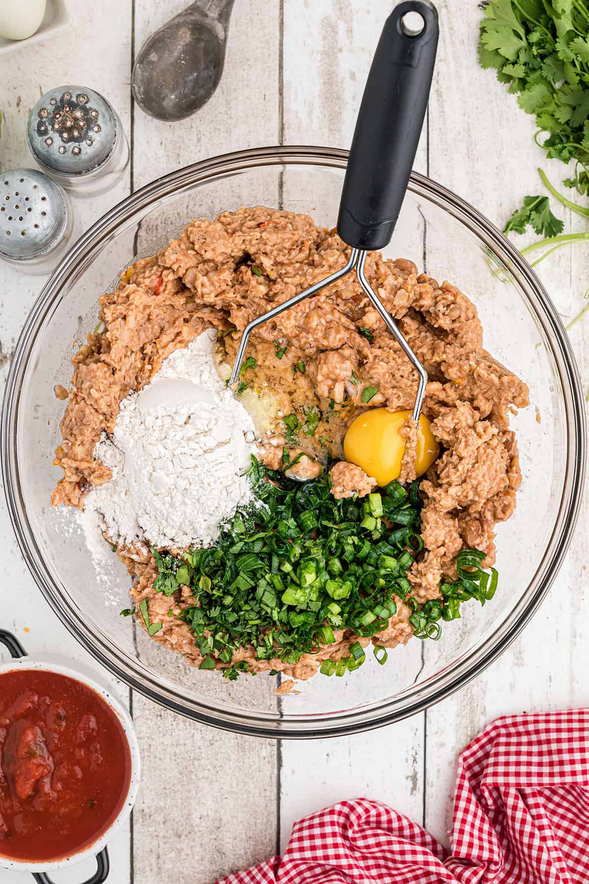 Flour, egg, and remaining ingredients added to mashed beans.