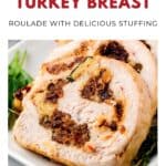 Sliced turkey roulade with stuffing, garnished with herbs on a white plate.