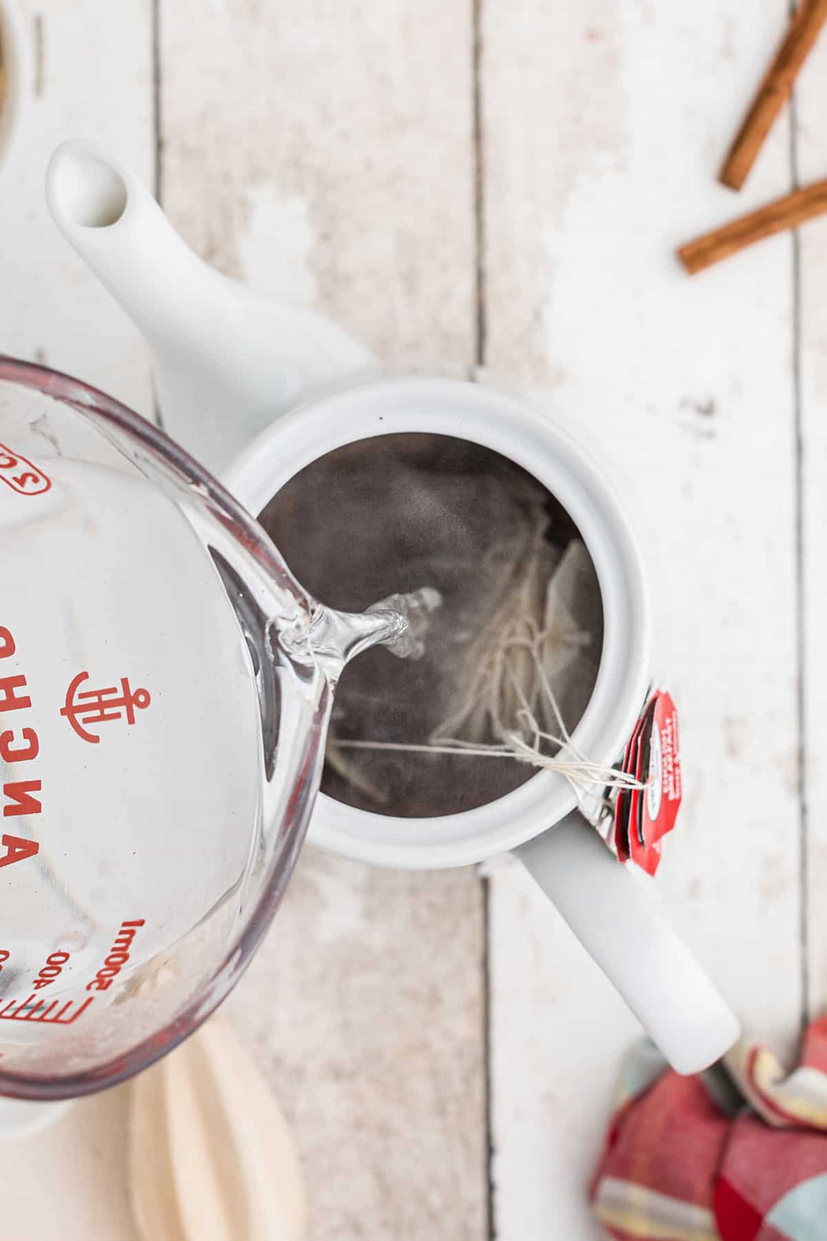 Pouring boiling water over tea bags.