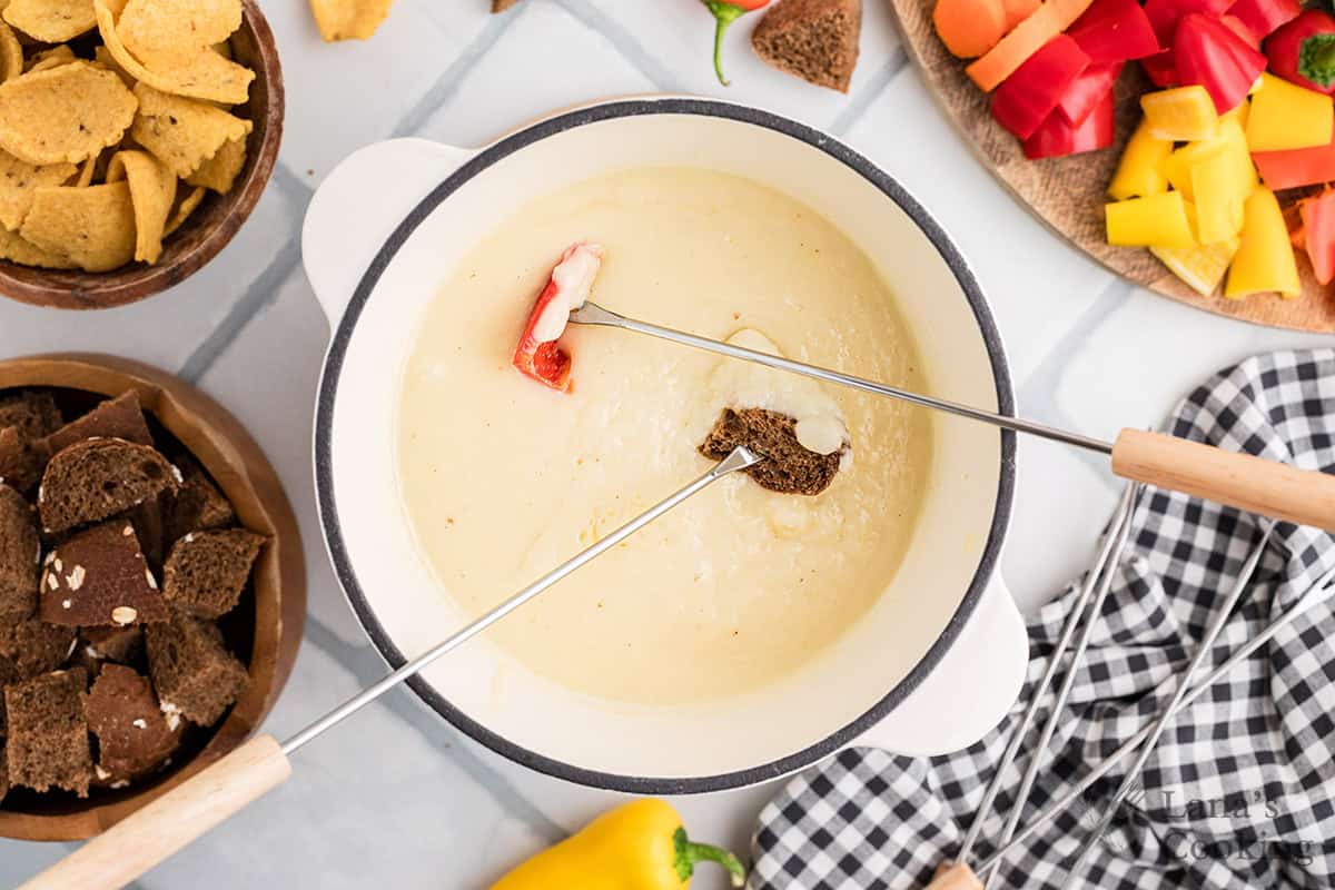 Fondue pot filled with cheese fondue>