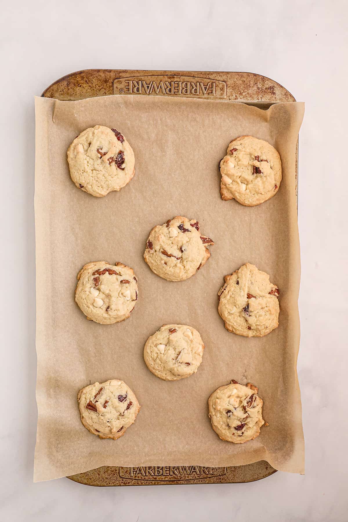 Baked cookies on a parchment lined baking sheet.