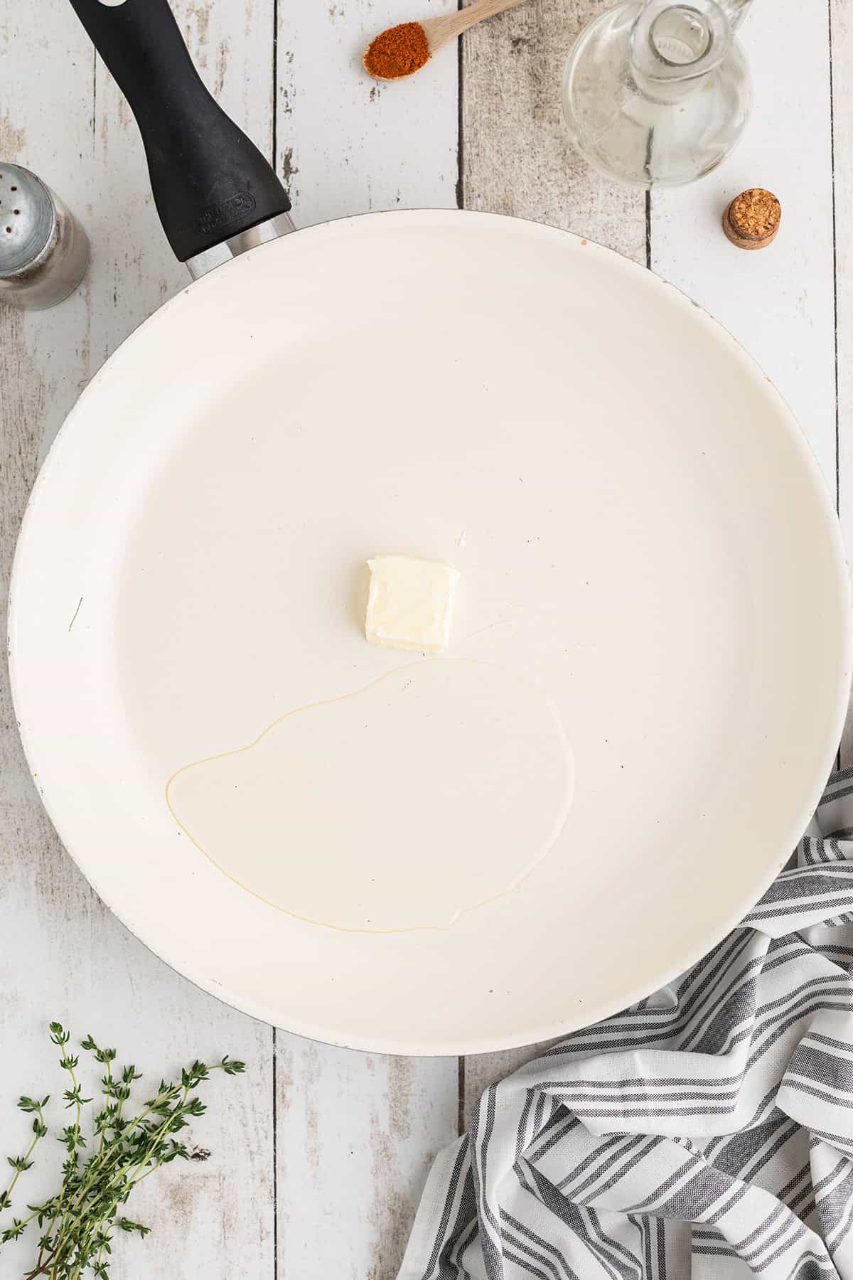 Butter melting in a skillet with oil.