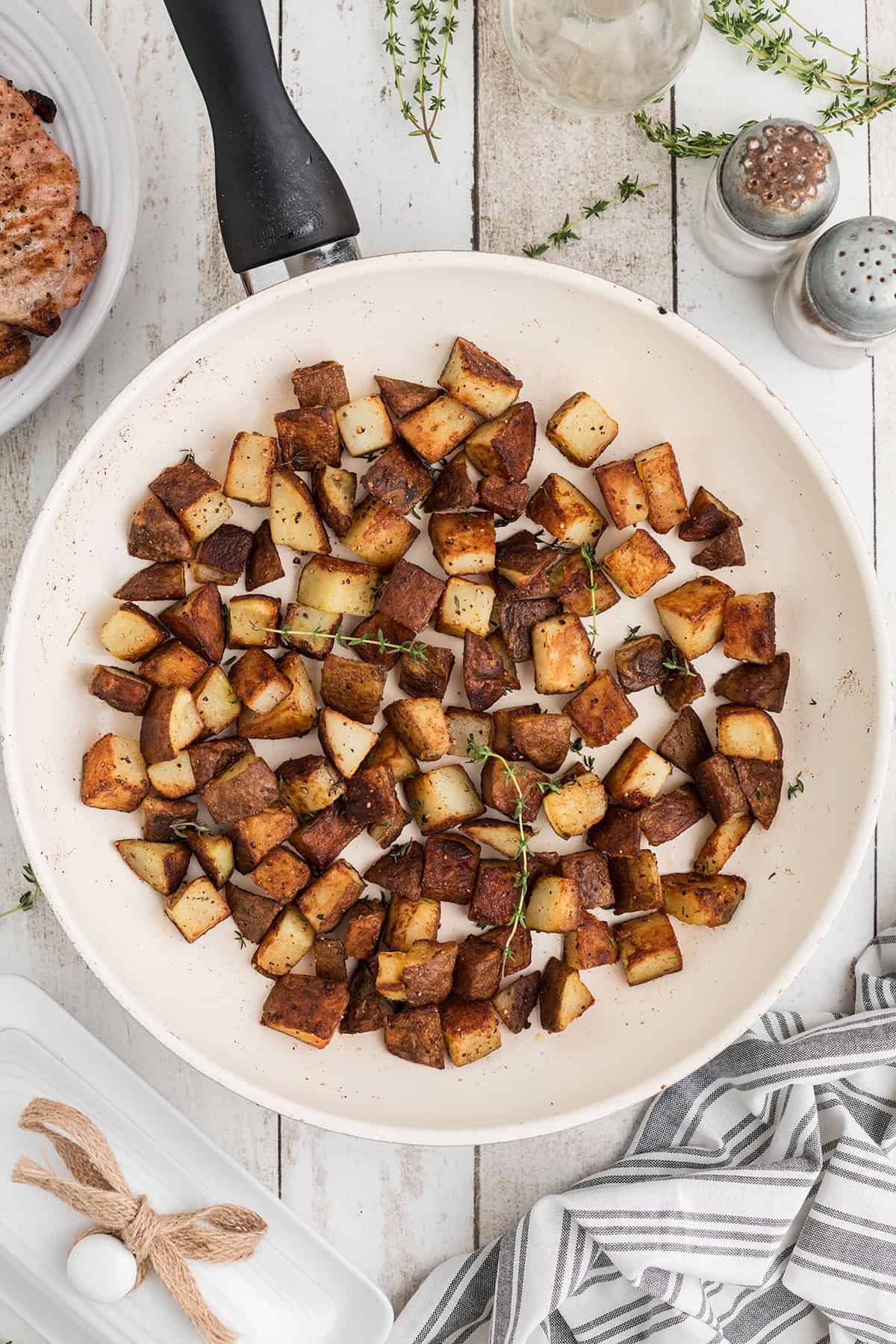 Browned potatoes in the skillet.