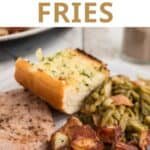 Home fries on a plate with green beans and ham.