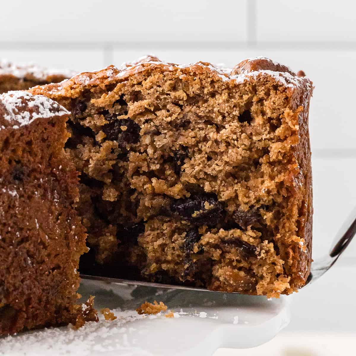 A slice of cake held on a spatula.