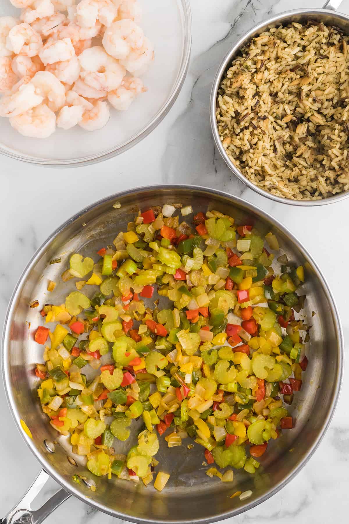 Vegetables cooking in a large skillet.