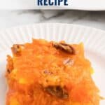 A serving of bright orange Sunshine Salad with pecans on a white plate; text overlay says Sunshine Salad Recipe.