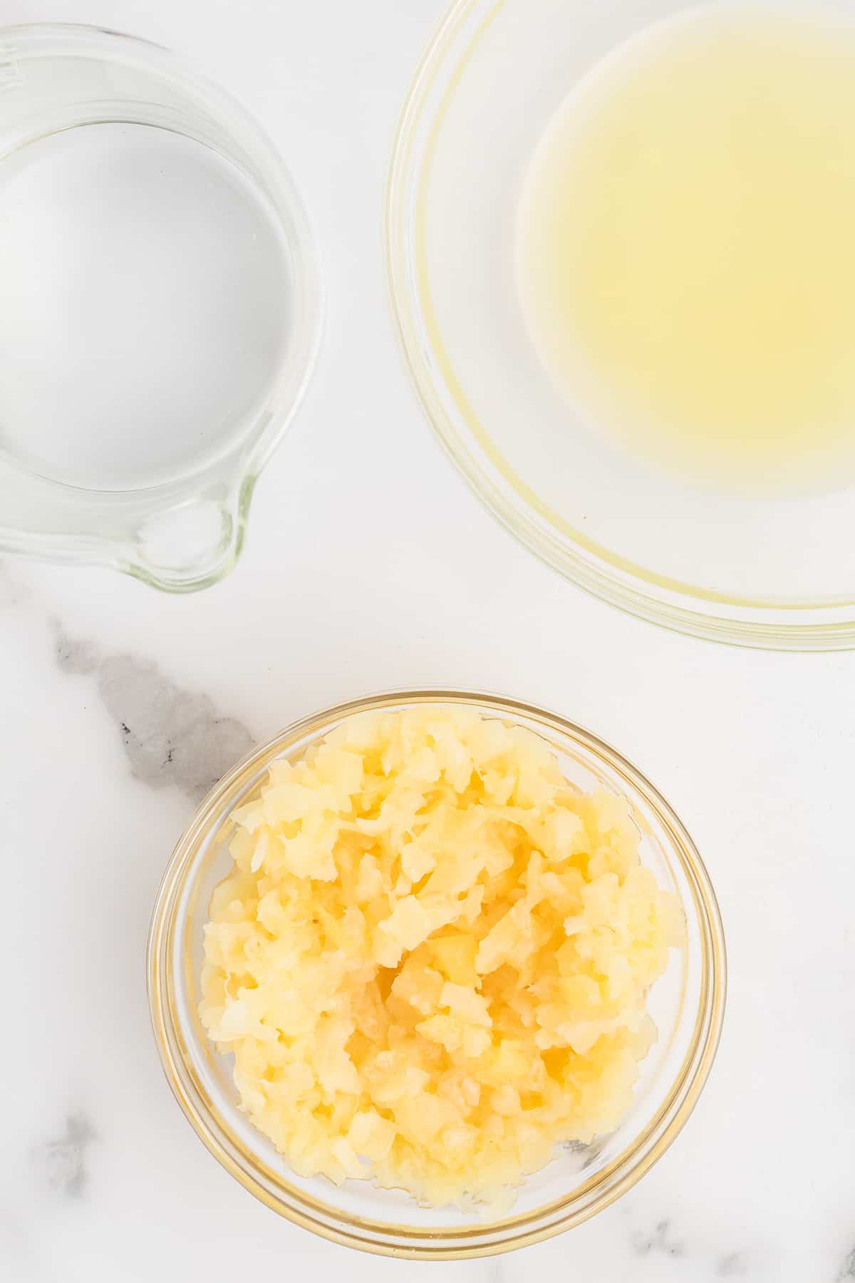 Drained crushed pineapple in a bowl.