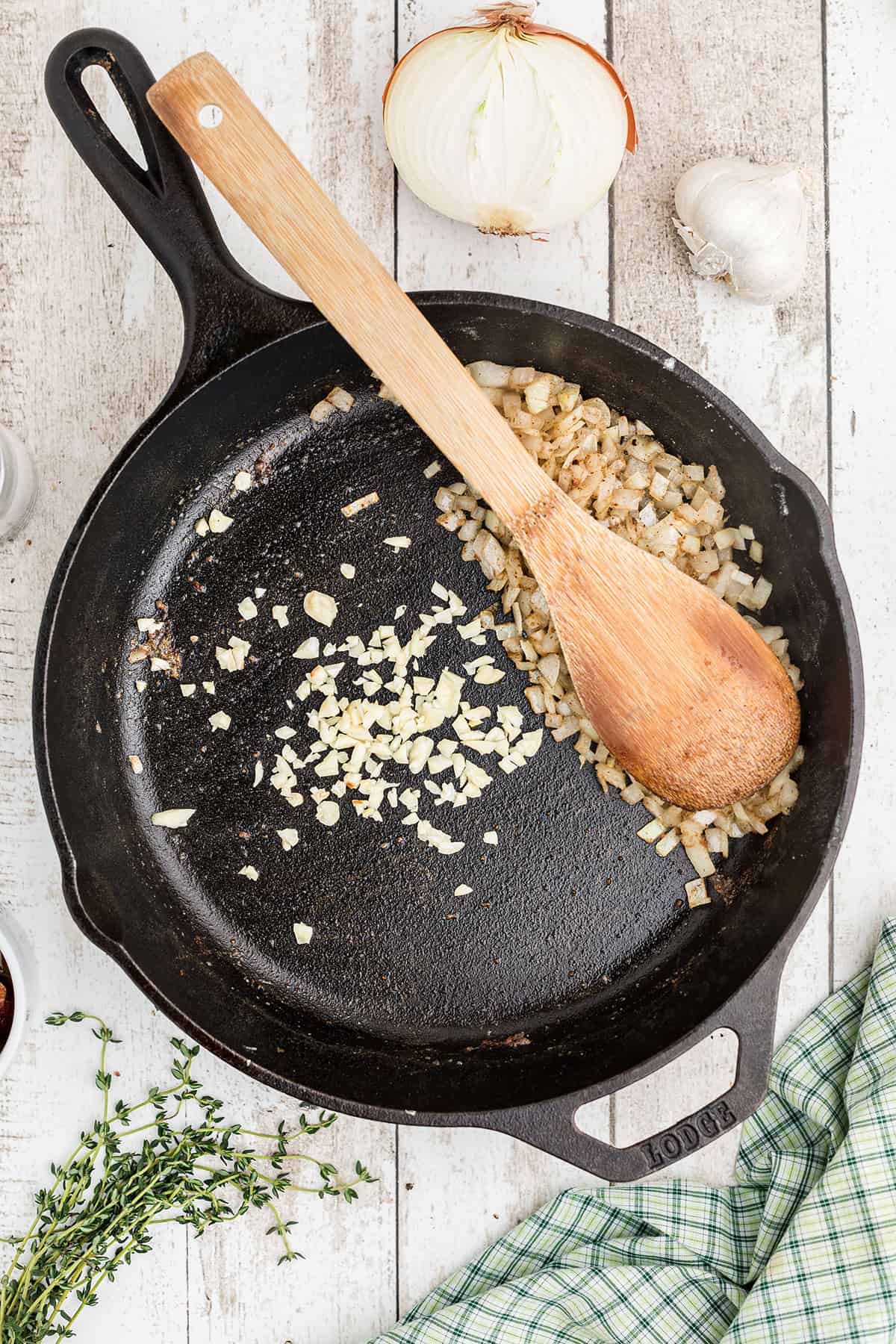 Onion and garlic cooking in a skillet.