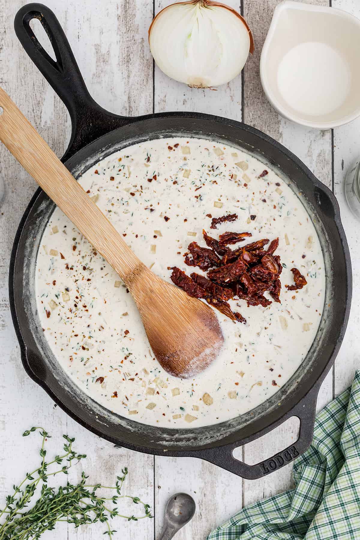 Parmesan cheese and other ingredients added to the skillet.