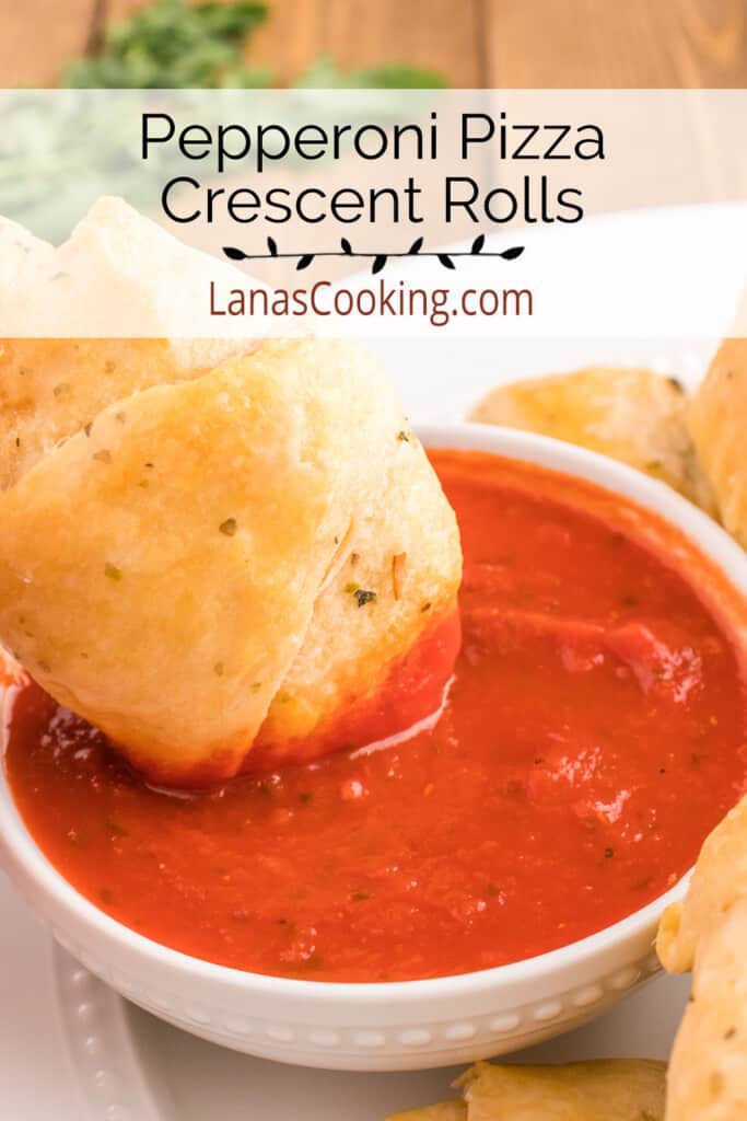 Pizza roll being dipped into sauce.