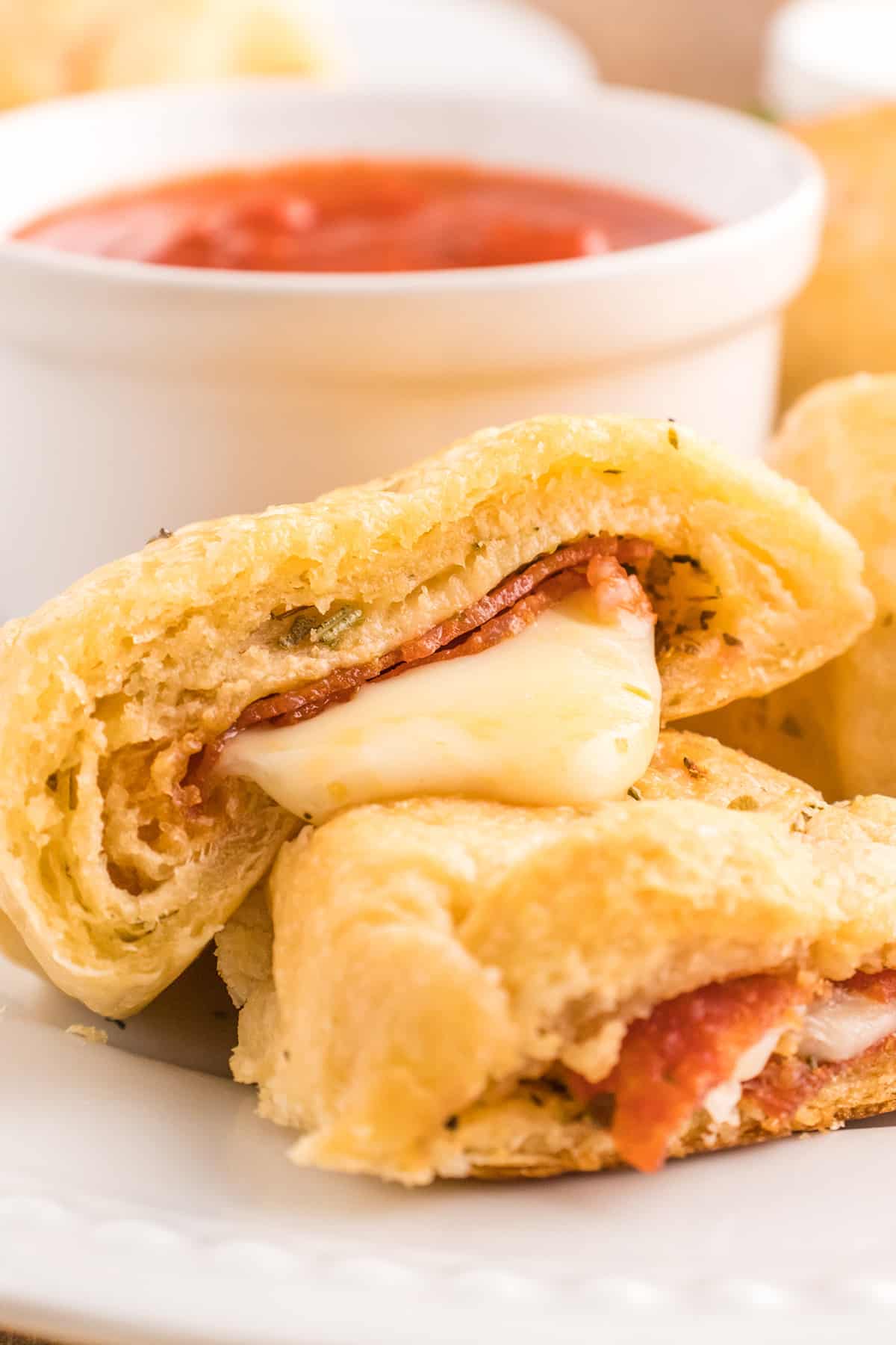 Pizza roll showing melty cheese running out.