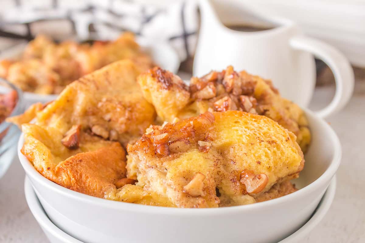 A serving of french toast casserole in a white bowl.