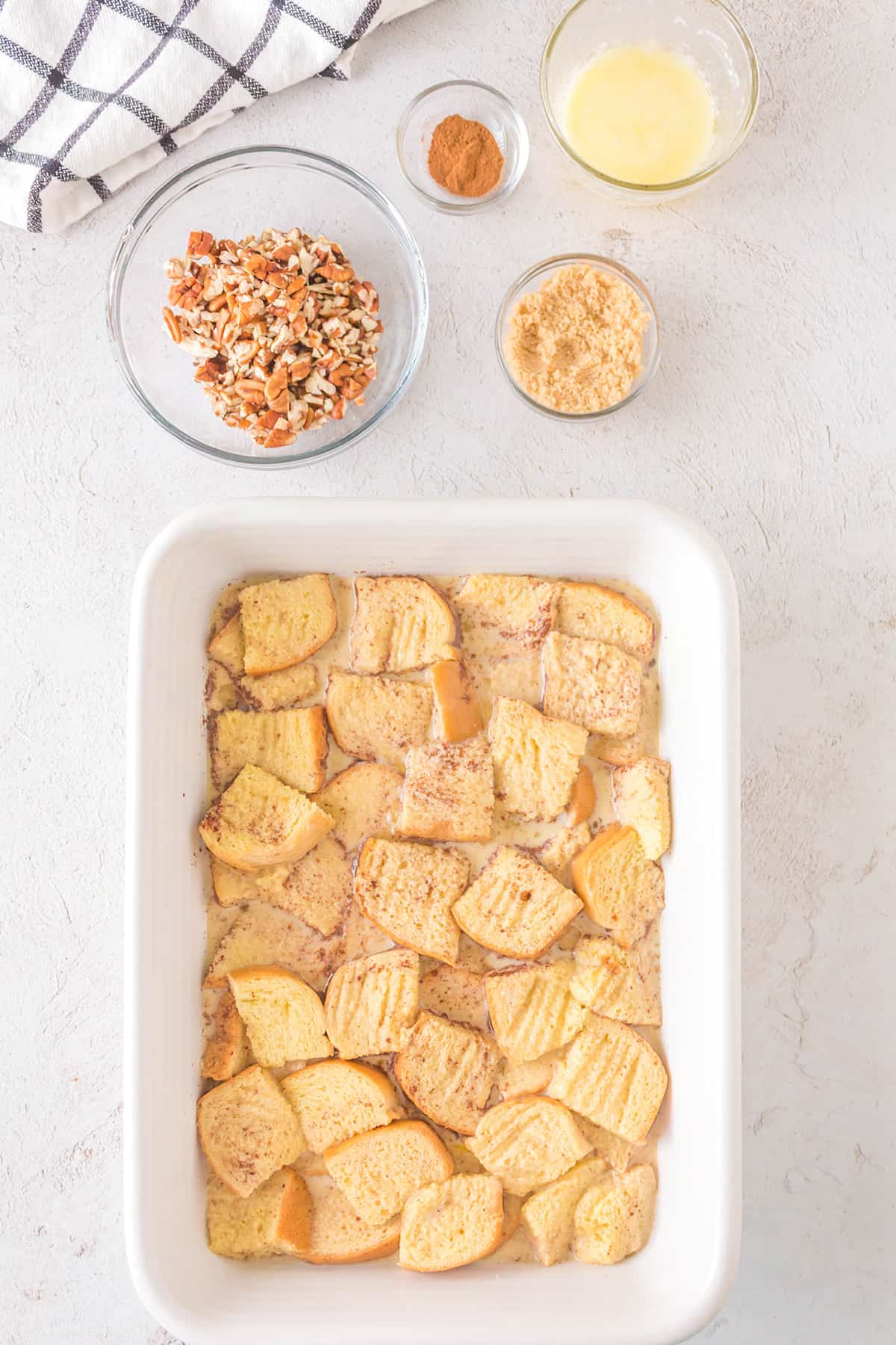 Custard mixture poured over bread cubes.